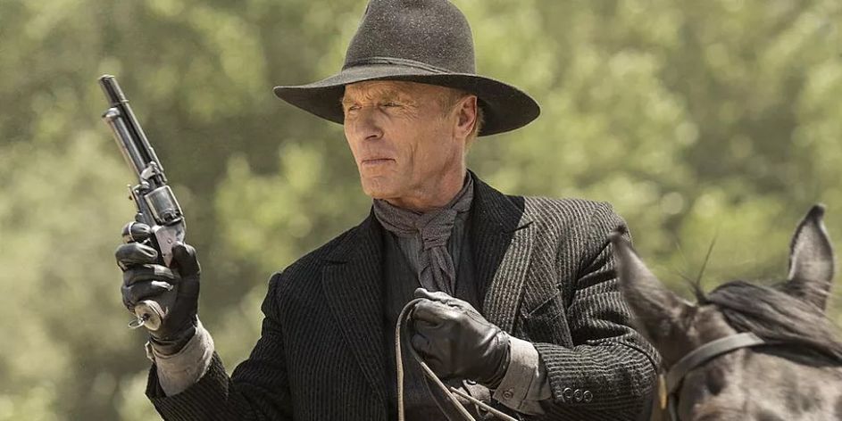 the-Man-in-Black-from-Westworld-holding-a-gun-and-riding-a-horse